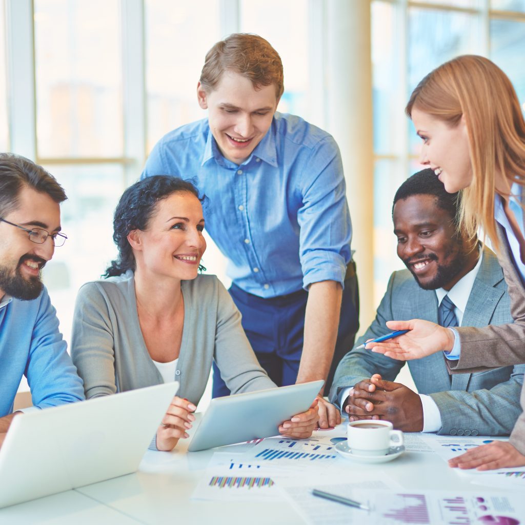 Group of business partners discussing strategies at meeting in office
